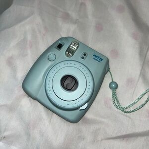 Light blue used instax mini 8 Polaroid camera, still in perfect condition.